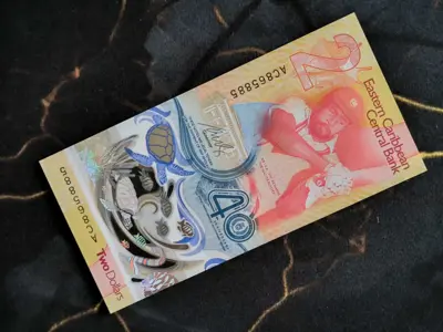 Обява: Банкнота - Източни Кариби - 2 долара (юбилейна) UNC | 2023г.
